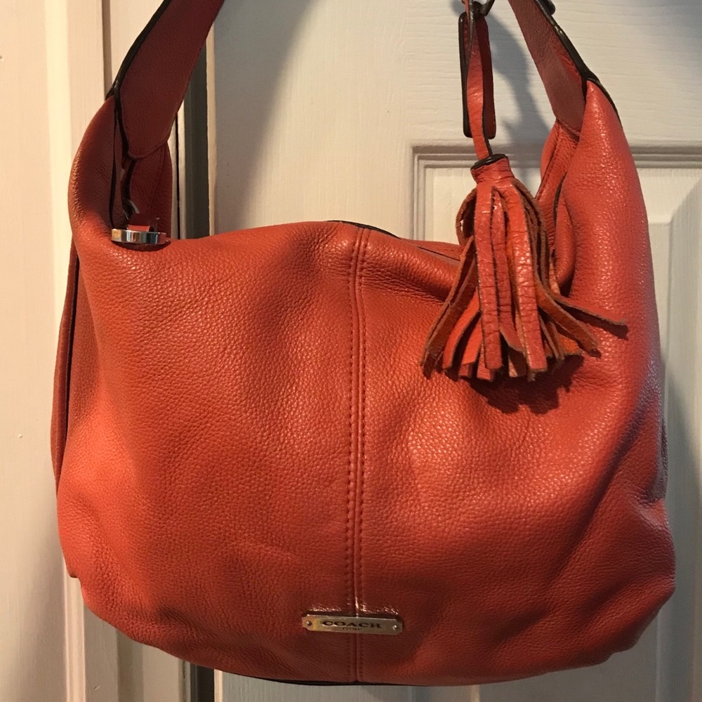 Coral and silver Coach shoulder bag.
